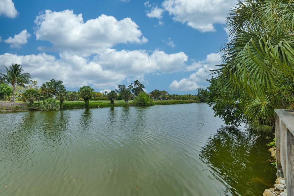 a view of a river with palm trees and clouds at Sandpebble 4c in Sanibel