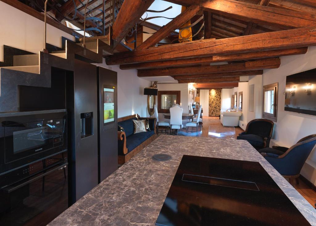 a kitchen and living room with wooden ceilings at LaLux Venezia in Venice