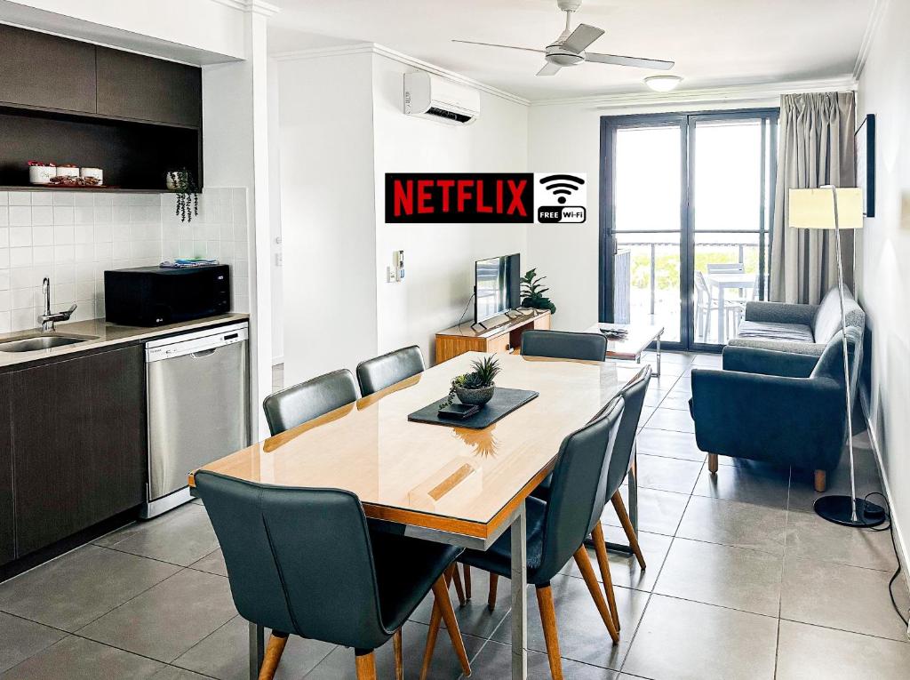 a kitchen and dining room with a table and chairs at WhitsunStays - The Regal (2br/2bth, Central) in Mackay