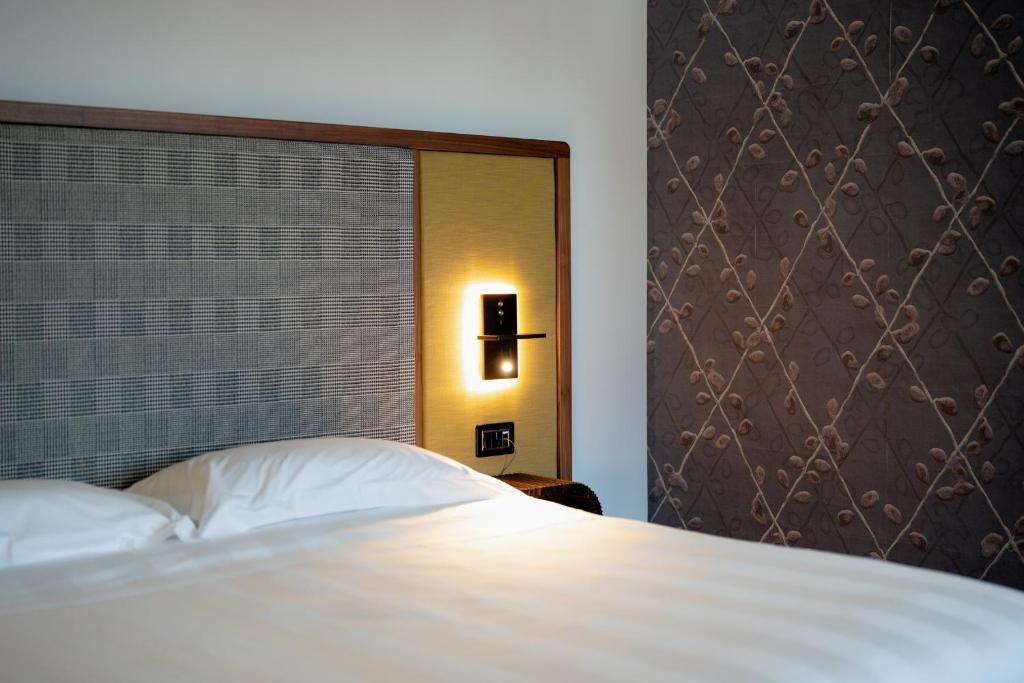 Postel nebo postele na pokoji v ubytování Lo Stemma Luxury Boutique Hotel
