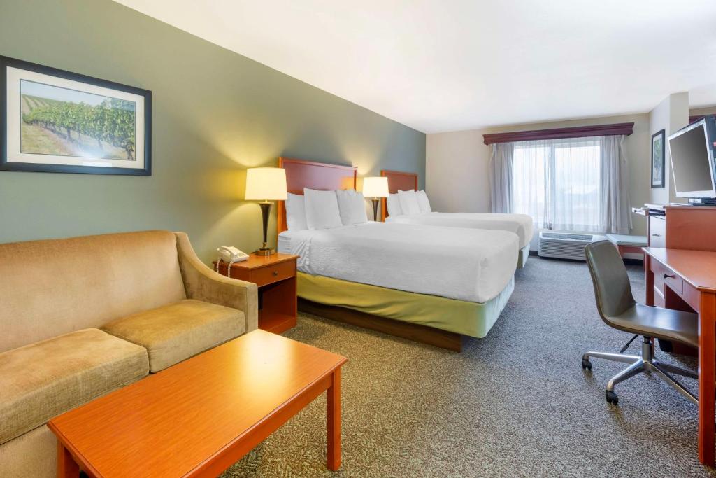a hotel room with a bed and a couch at Best Western PLUS Walla Walla Suites Inn in Walla Walla
