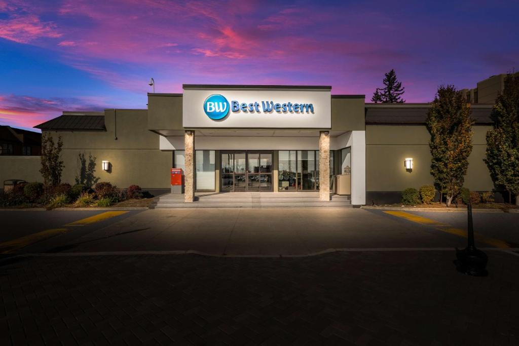 a building with a sign for a car dealership at Best Western Parkway Hotel Toronto North in Richmond Hill