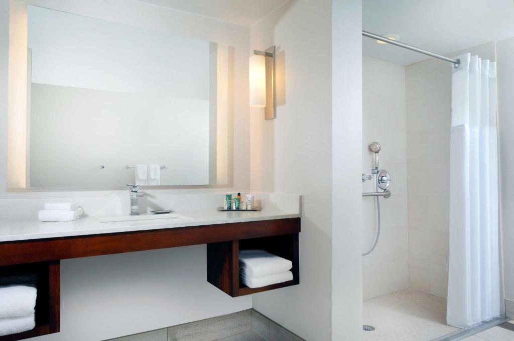 a bathroom with a sink and a shower at Hilton Naples in Naples