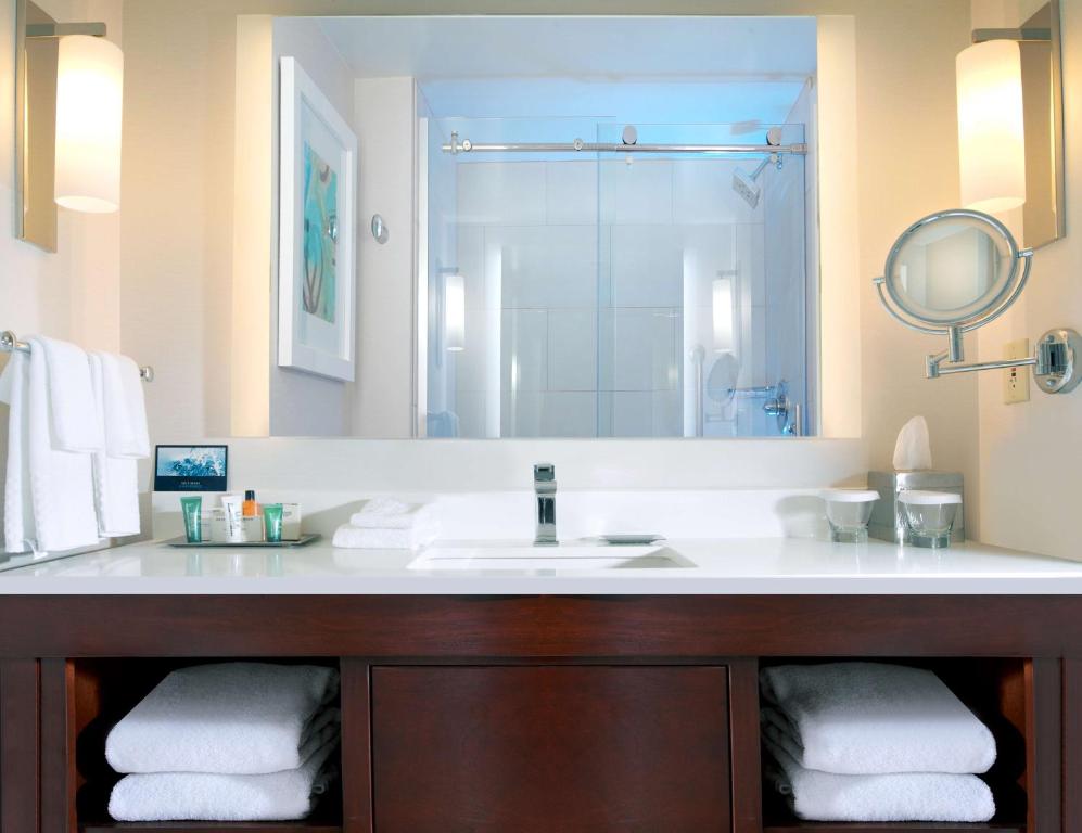 a bathroom with a sink and a mirror at Hilton Naples in Naples
