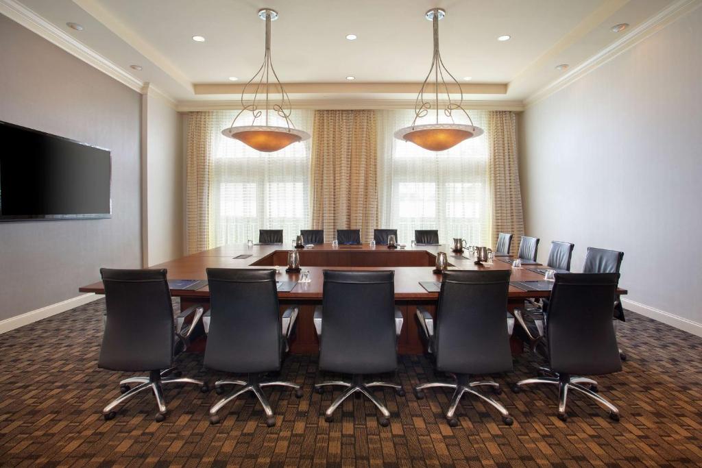 a conference room with a large table and chairs at Hilton Naples in Naples