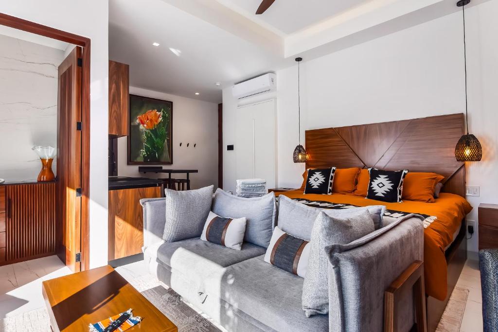 a living room with a couch and a bed at Madero 320 - 310 in Puerto Vallarta