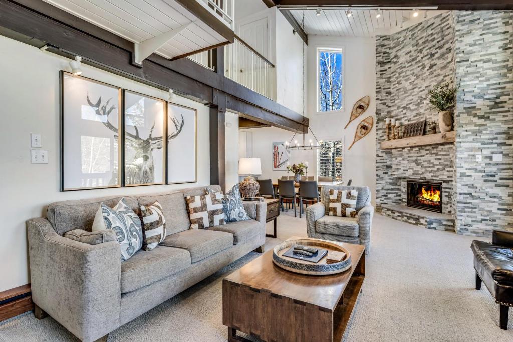 a living room with a couch and a fireplace at Interlude Condominiums 3-Bedroom Unit 301 in Snowmass Village