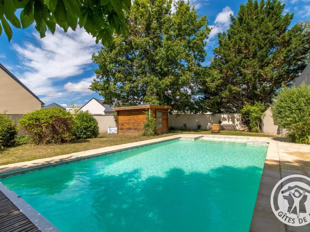 a swimming pool in a yard with trees at Gîte Tiercé, 3 pièces, 4 personnes - FR-1-622-44 in Tiercé