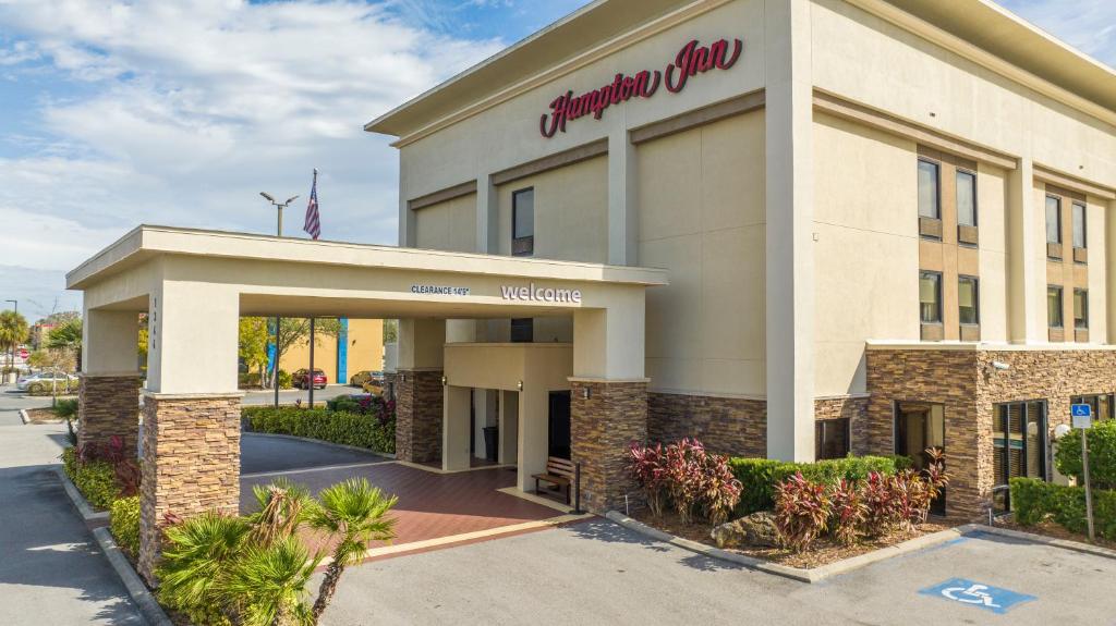 a building with a sign for a shopping center at Hampton Inn by Hilton Spring Hill in Timber Pines