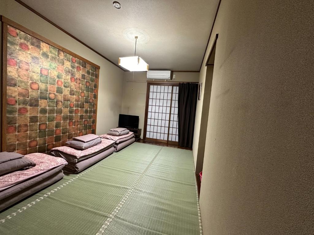 Postel nebo postele na pokoji v ubytování Minato Oasis Numazu / 沼津観光の中心、伊豆観光の拠点に好立地！沼津港に位置し交通・飲食・コンビニ等至便です！