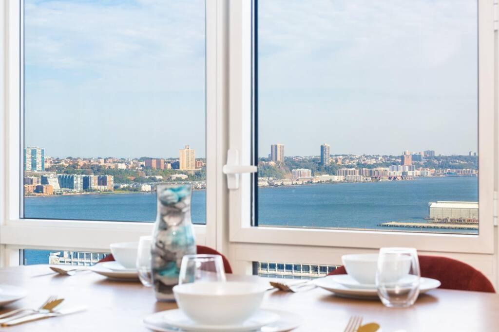 a table with a view of the city from a window at Super Luxury Penthouse 3bd 3bath in Jersey City