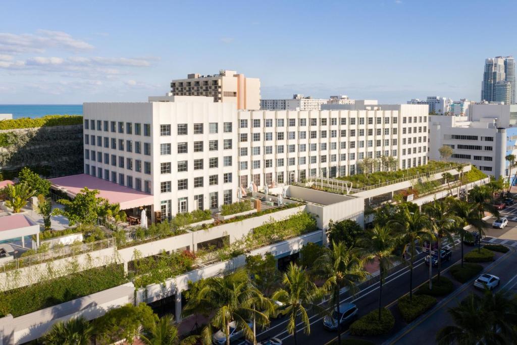 an aerial view of a large white building with palm trees at The Goodtime Hotel, Miami Beach a Tribute Portfolio Hotel in Miami Beach