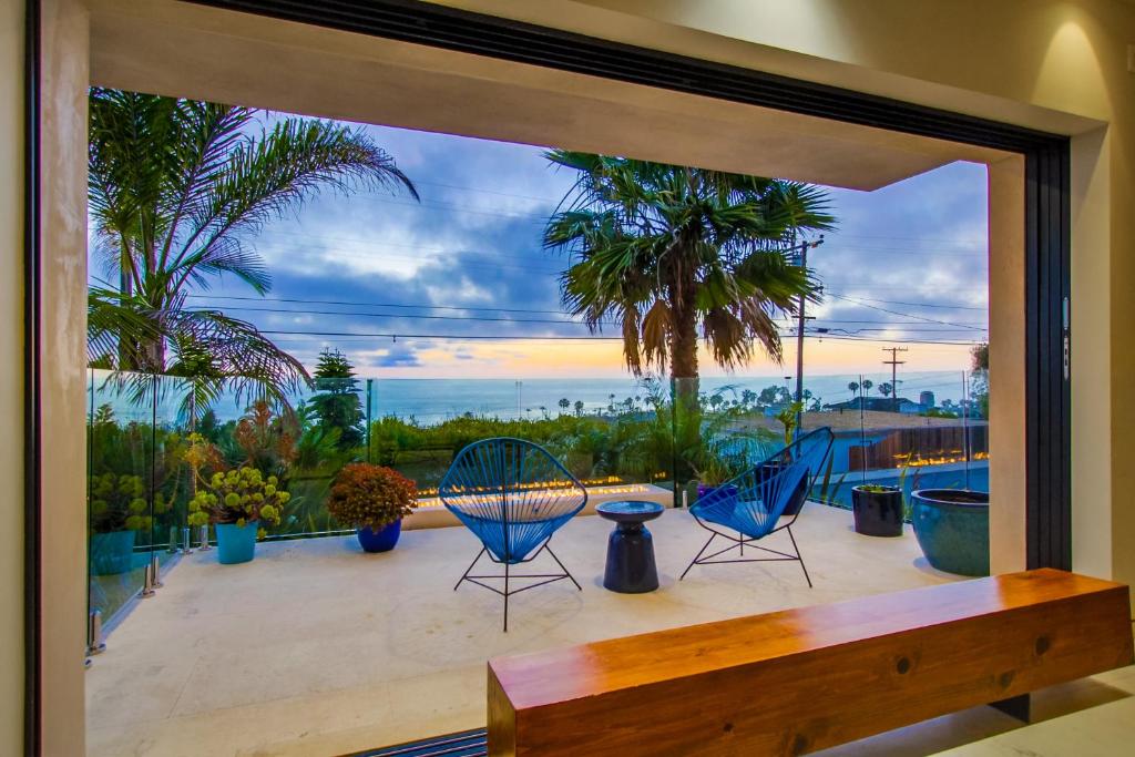 a view of a patio with two chairs and a table at Sunset Cliffs Modern Luxury Estate w Ocean Views, Oversized Spa, AC, Yard! in San Diego