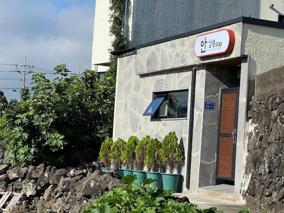 a building with a window and a sign on it at An Gimnyeong Stay in Jeju