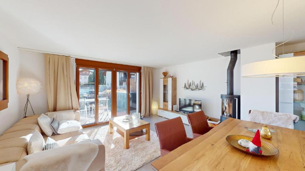 a living room with a table and a couch at Family holiday home Tgiampi Sot Lantsch Lenzerheide in Lenz