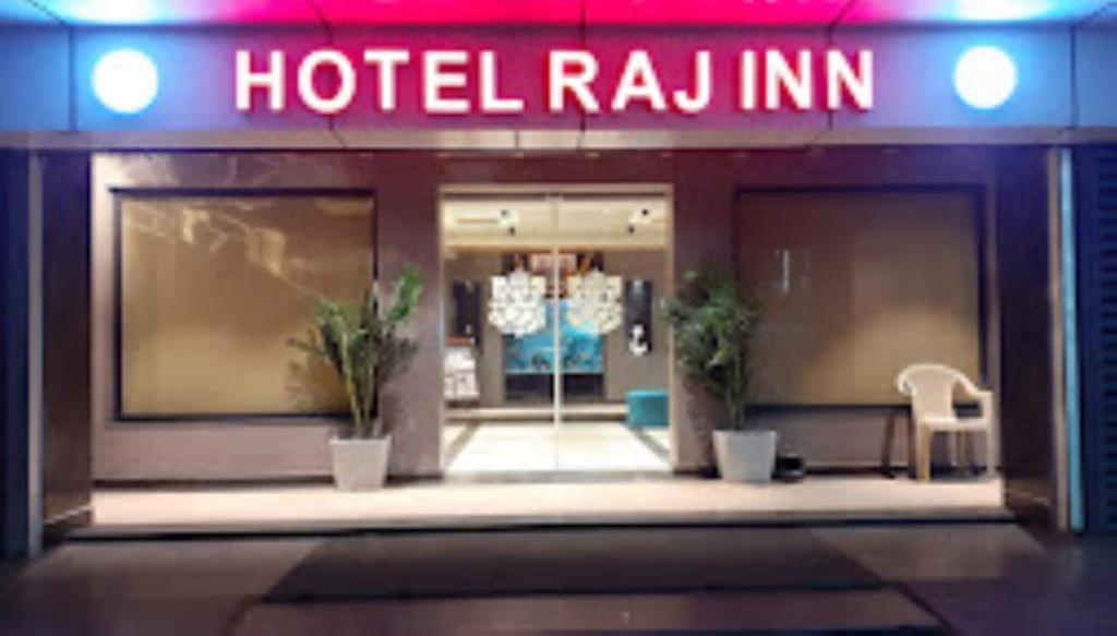 a hotel room with a hotelulum sign on the door at Hotel Raj Inn Bhubaneswar in Bhubaneshwar