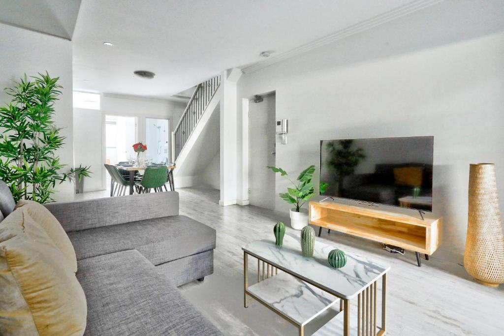 a living room with a couch and a table at Superb 3 Bedroom Apartment Surry Hills in Sydney