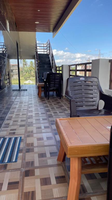 a patio with chairs and a table on a balcony at Mamatha Guest inn in Hampi