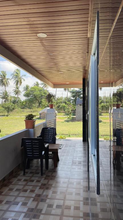 a porch with two benches and a table on a patio at Mamatha Guest inn in Hampi