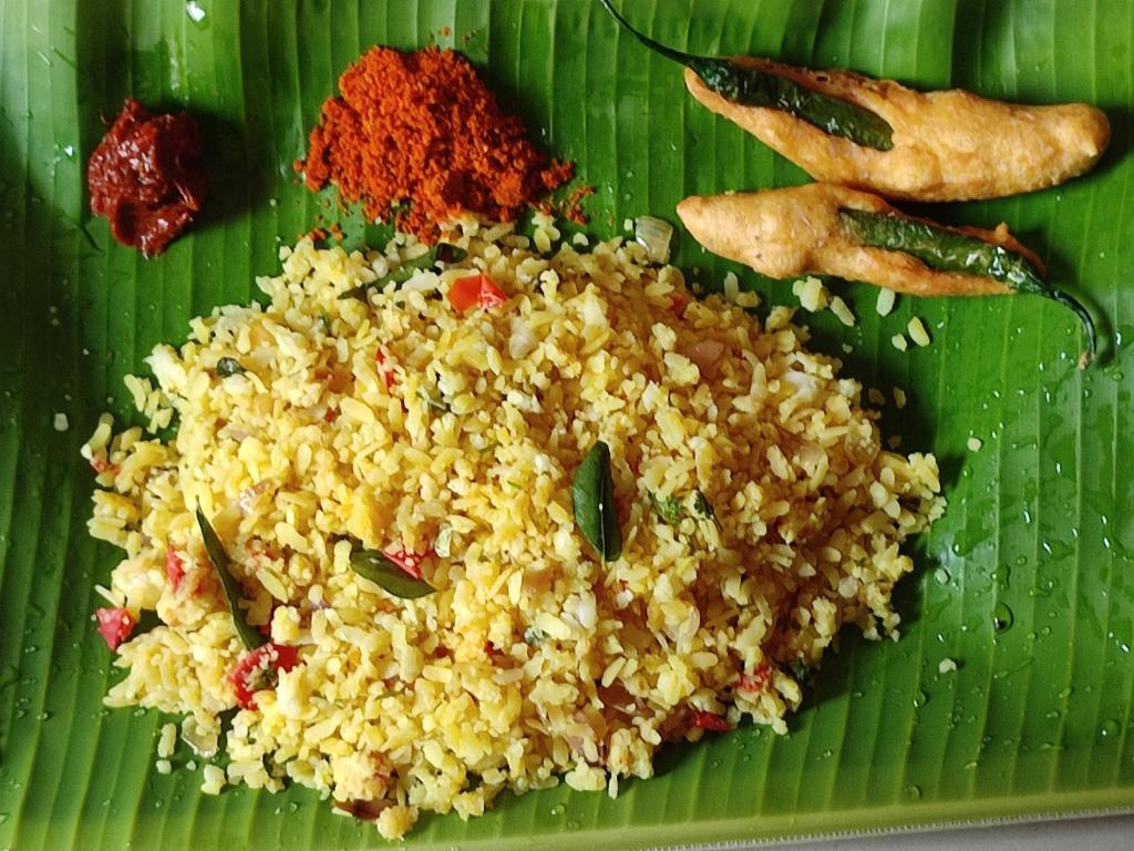 a plate of rice on a green leaf at Mamatha Guest inn in Hampi