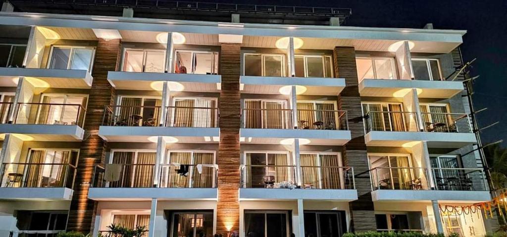 an apartment building with lights on the balconies at Hotel Sonar Bangla Puri in Puri