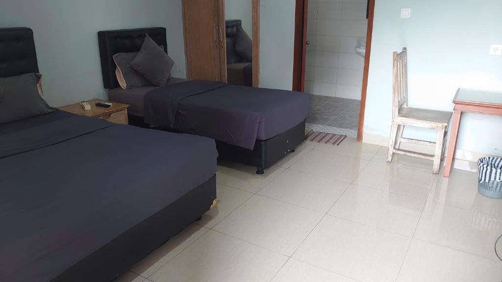 Postel nebo postele na pokoji v ubytování Nuka Beach Inn