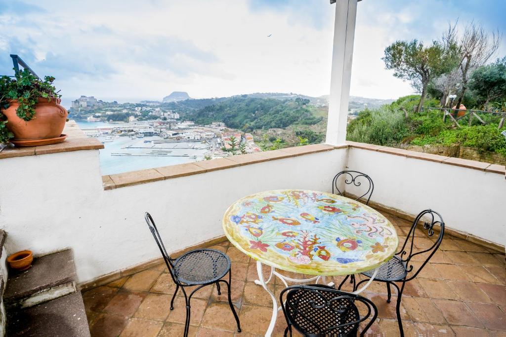 a table and chairs on a balcony with a view at Baia dei Cesari in Bacoli