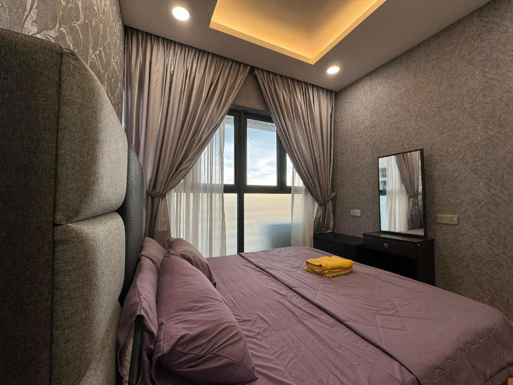 um quarto com uma cama roxa e uma janela em Dangabay 2bedroom Seaview Luxury Design Unit em Johor Bahru