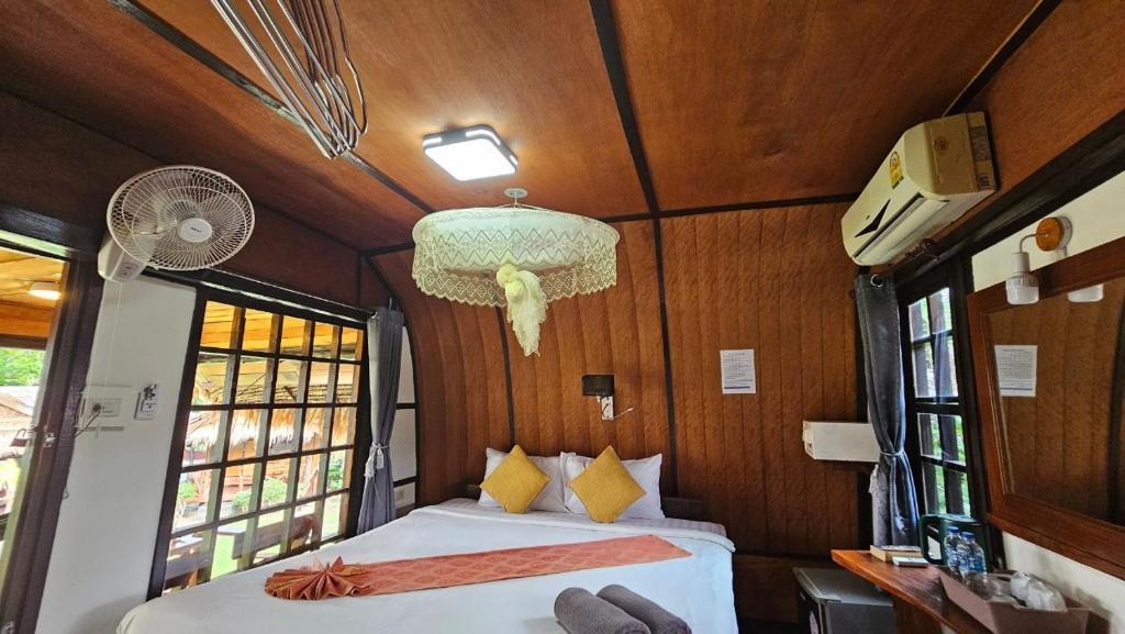 a bedroom in a train with a bed and windows at Eden Lanta Bungalow in Phra Ae beach