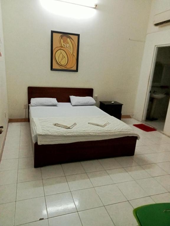 ein Schlafzimmer mit einem Bett in einem Zimmer in der Unterkunft Minh Hoàng in Vũng Tàu