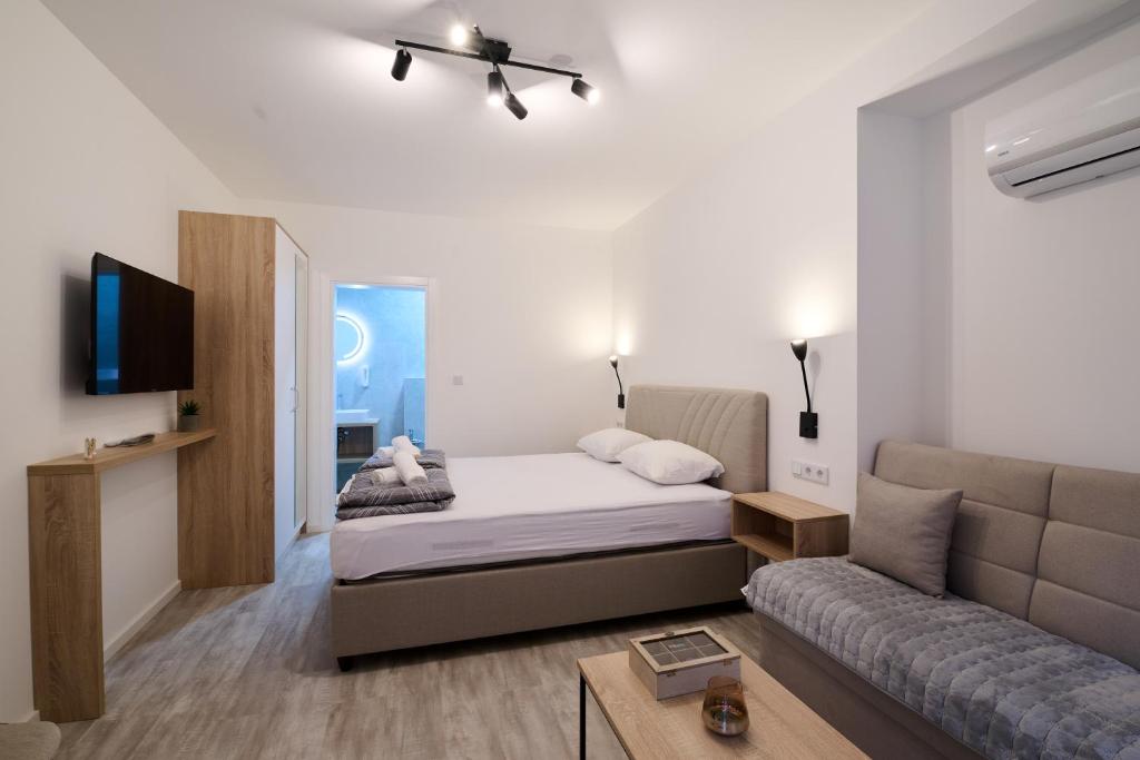 a living room with a bed and a couch at Sultan Apartments in Mostar