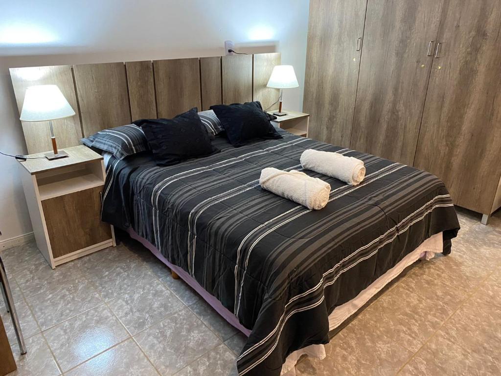 a bedroom with a large bed with two pillows on it at Descanso Río Grande in Río Grande