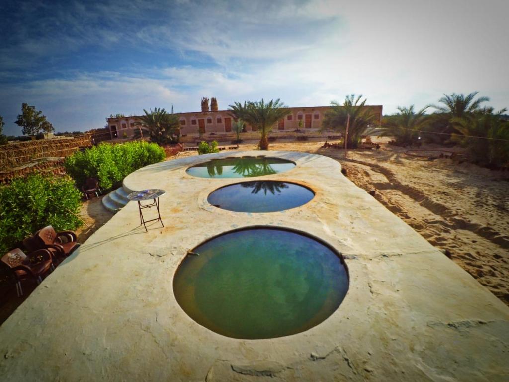two large pools of water on top of a building at Santarya hotel in Siwa