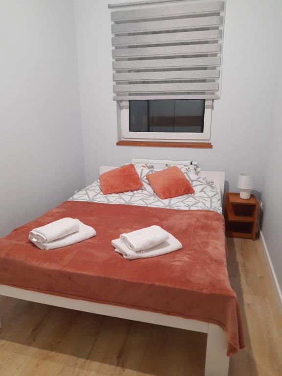 En eller flere senge i et værelse på Przytulny Apartament na Strzeleckiej