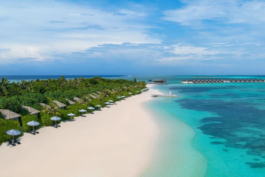 an aerial view of a beach with umbrellas and the ocean at Le Meridien Maldives Resort & Spa in Lhaviyani Atoll