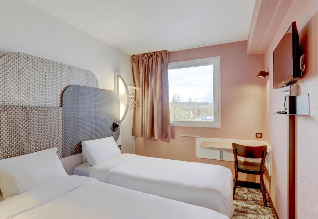 Postel nebo postele na pokoji v ubytování B&B HOTEL Montluçon Saint-Victor