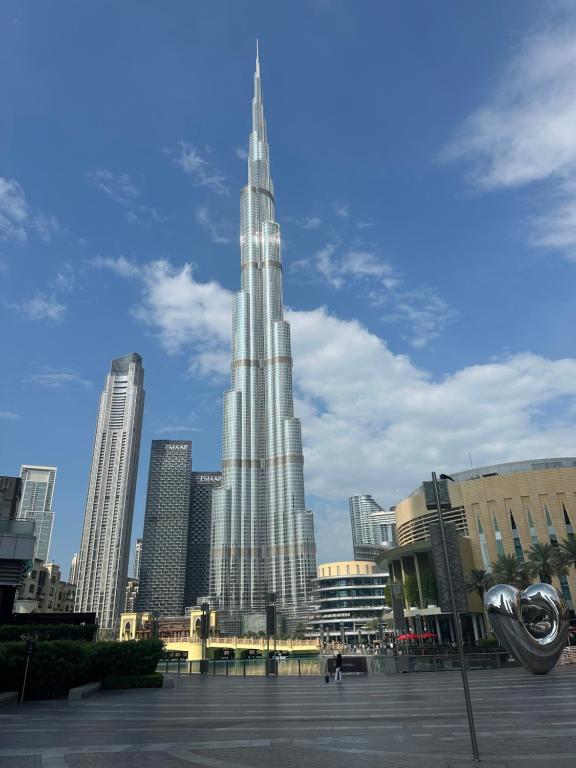 a large tall building in a city with buildings at Burj Khalifa in Dubai