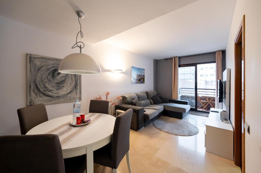 una sala de estar con una mesa y un sofá en Comfy Downtown + Private terrace, en Barcelona
