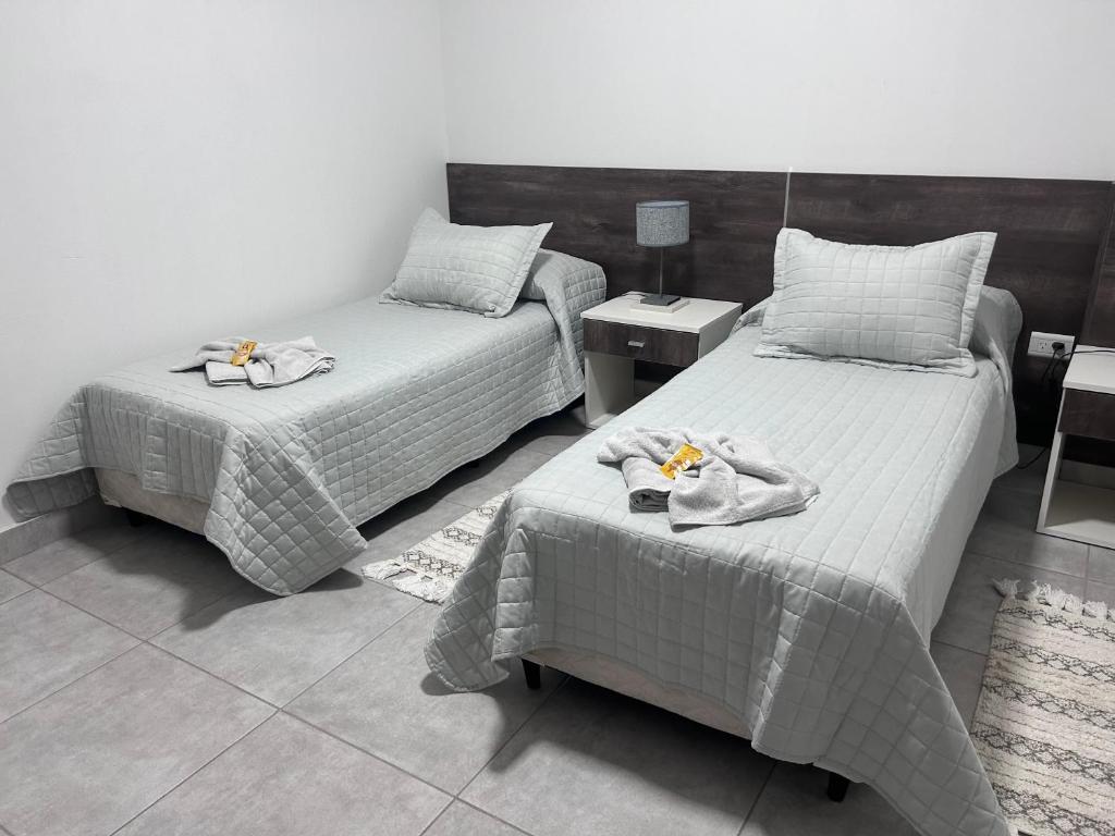 a bedroom with two beds with towels on them at Apart Luro III in Santa Rosa