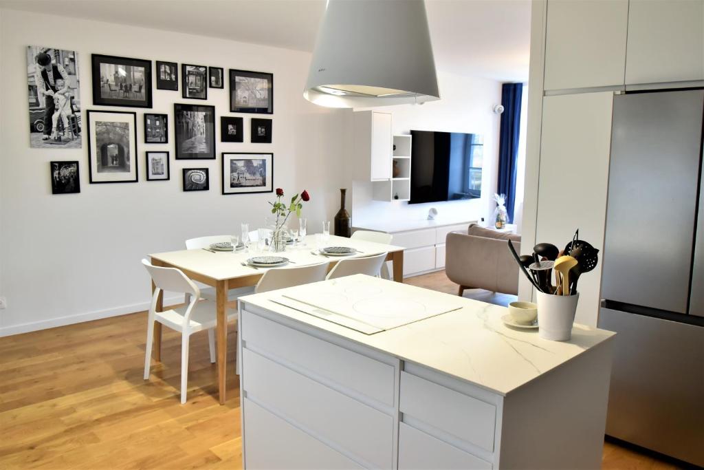 a kitchen with a table and a dining room at La Maison du Quai Triplex de charme 4 étoiles en hyper centre avec SPA in Landerneau