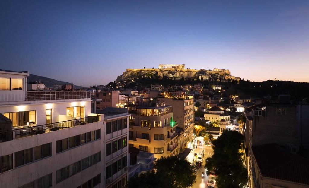 a view of a city at night with a mountain at Zoe Monastiraki in Athens