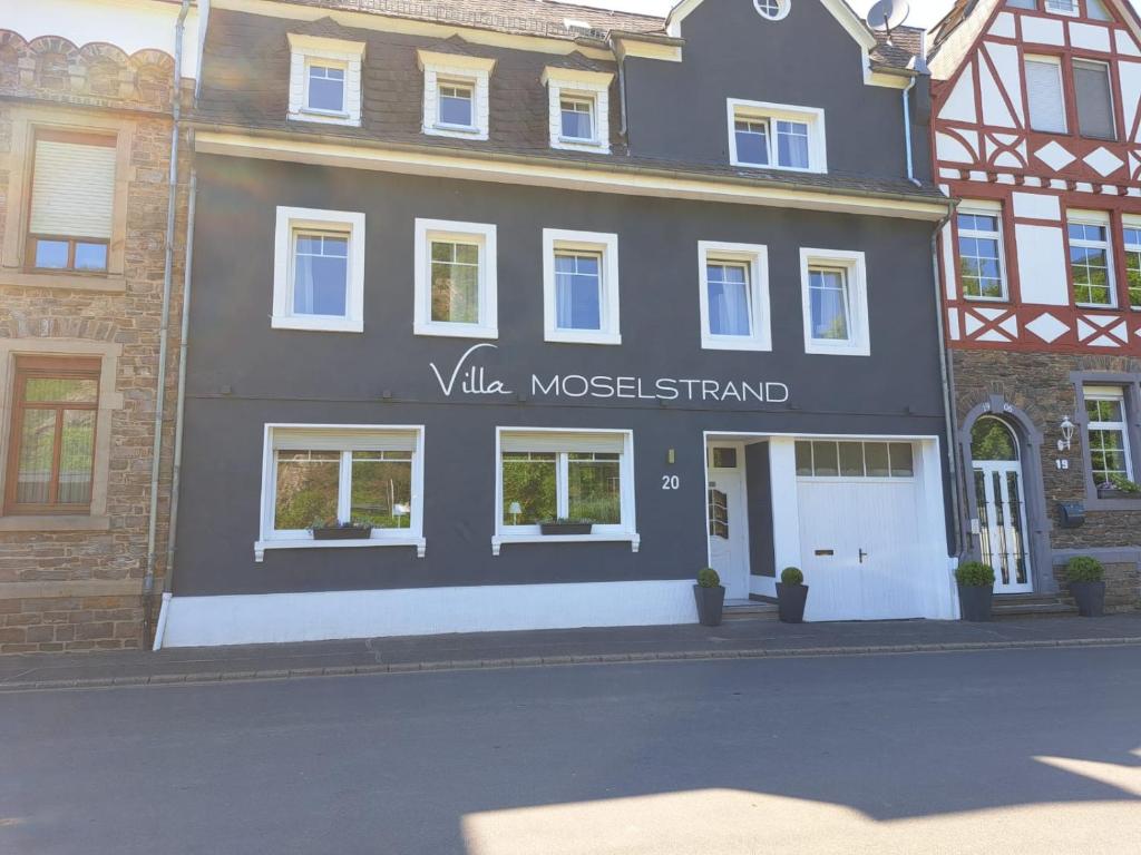 ein Gebäude mit einem Schild, das den bescheidenen Stand der Villa liest in der Unterkunft Villa Moselstrand in Moselkern