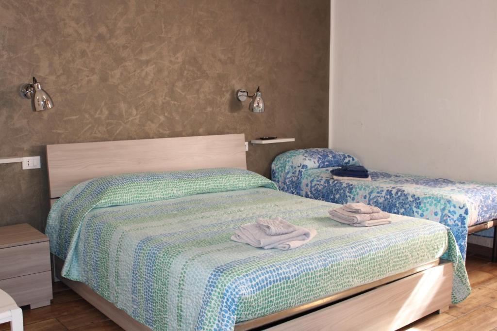 A bed or beds in a room at Alghero Budget