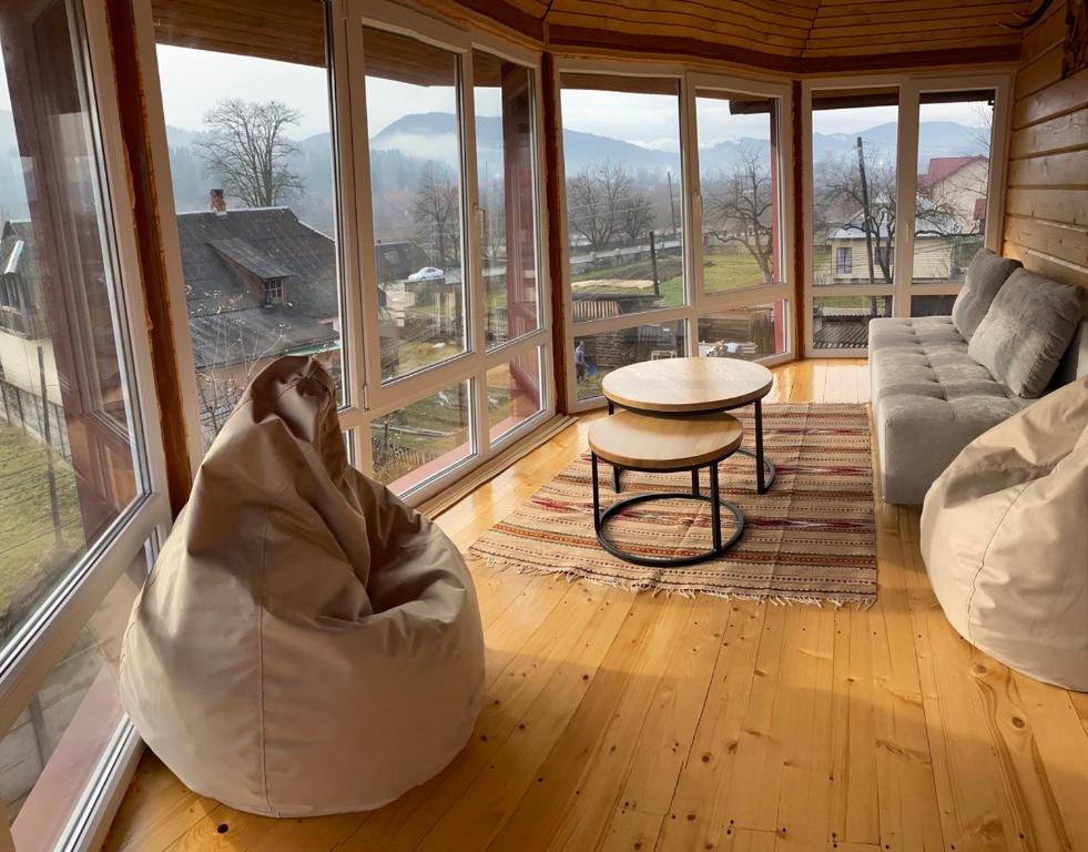 a dog laying on a couch in a room with windows at Domashnya Oselya in Verkhovyna