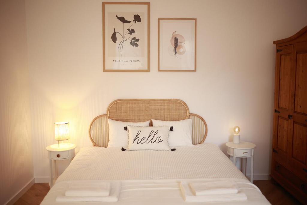 1 dormitorio con 1 cama con 2 mesas y 2 cuadros en la pared en PATRU Apartment, en Cluj-Napoca
