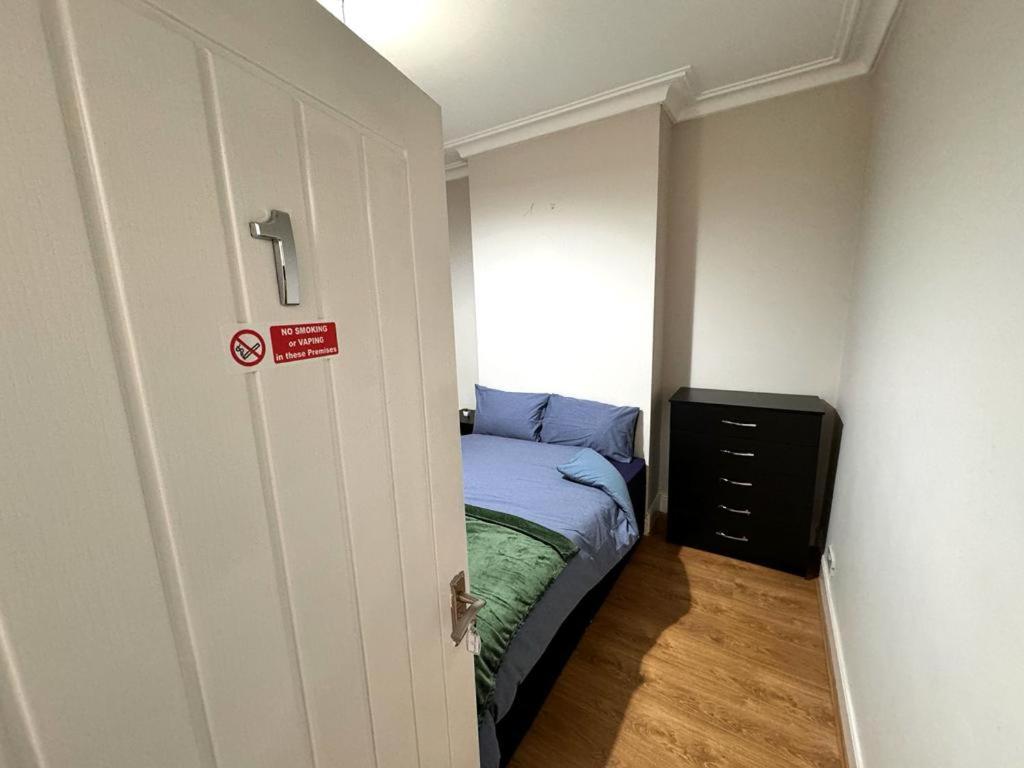 a small bedroom with a small bed and a window at Bluebells of Kathleen near Birmingham Airport in Birmingham
