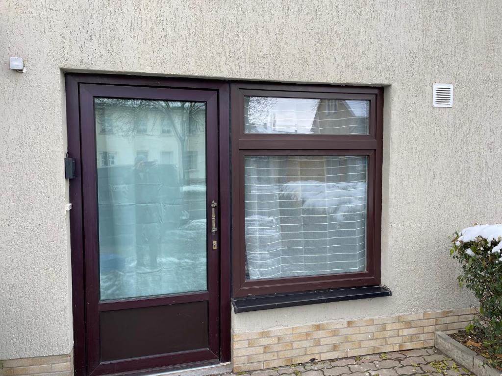 a brown door with two windows on a building at Einfaches Appartement "Daniel" in Halle in Kröllwitz