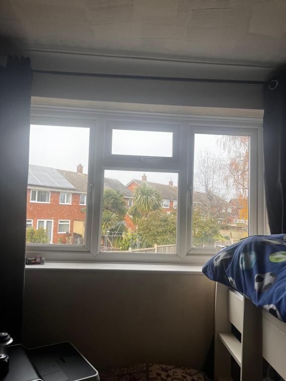 a window in a bedroom with a view of a house at No name 