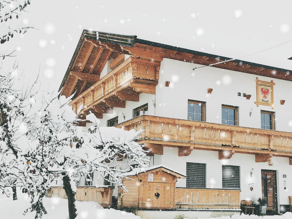 a large building covered in snow at Appartements Höpfl in Westendorf
