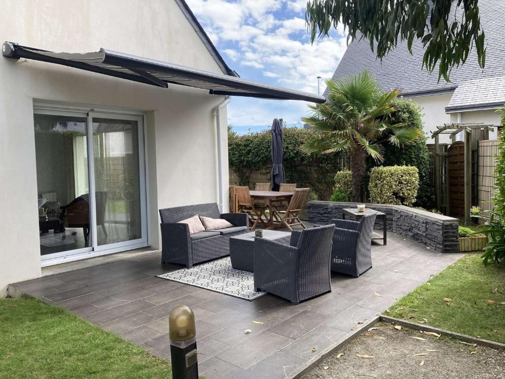 d'un patio avec des chaises et une table. dans l'établissement Maison 5P à Quiberon, 130m², proche plage, terrasse sud, jardin, garage, accepte animaux - FR-1-478-12, à Quiberon